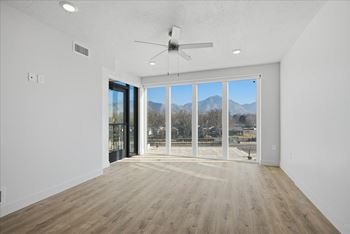 Room with ceiling fan, sliding glass doors and wooden floor2